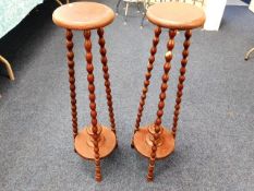 A pair of tall plant wooden plant stands with bobb