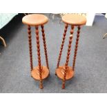 A pair of tall plant wooden plant stands with bobb