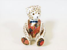 A Royal Crown Derby bear paperweight with gold sto