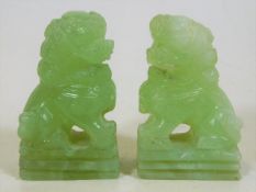 A pair of 1920's Chinese carved jade foo dogs