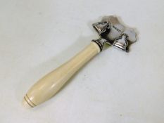 A 19thC. ivory handled hot plate holder