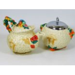 A Clarice Cliff teapot, two chips on inner rim & a similar biscuit barrel