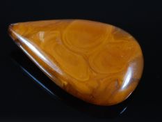 A large early 20thC. amber pendant