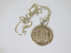 A 1741 silver piece of eight mounted with chain