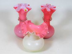 A pair of pink Victorian glass vases twinned with