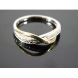 A 9ct two tone cross band diamond ring