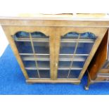 A walnut veneer floor standing book case