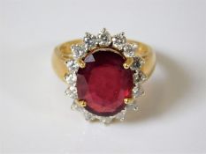 An 18ct gold ring with diamonds & red spinel