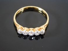 An 18ct gold ring set with five diamonds