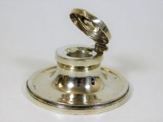 A silver capstan inkwell