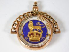 A 9ct gold mounted silver & enamelled shilling