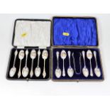 A set of six boxed silver spoons with tongs twinne