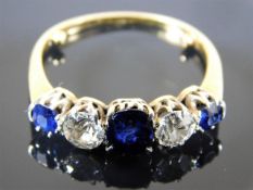 An 18ct gold ring with two diamonds of approx. one carat in total with three sapphires