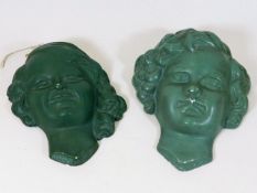 A pair of early 20thC. art deco plaster masks sign