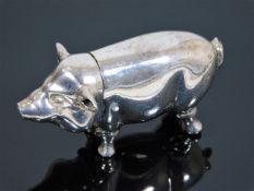 A silver pig in form of vesta case