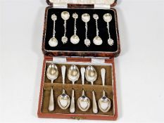 Two boxes of six silver spoons