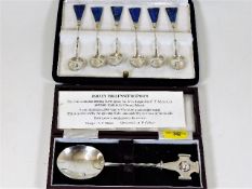 A silver commemorative spoon twinned with six silv
