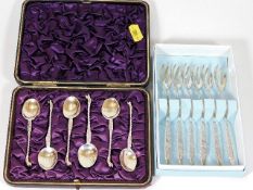A boxed set of silver spoons twinned with silver f