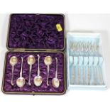 A boxed set of silver spoons twinned with silver f