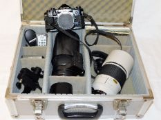 A Canon A1 camera with case, lenses & accessories