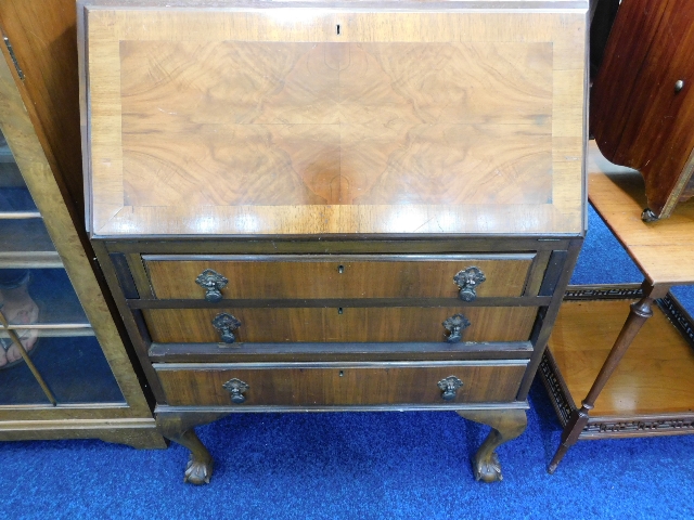 A mahogany veneer bureau with ball & claw feet