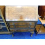 A mahogany veneer bureau with ball & claw feet