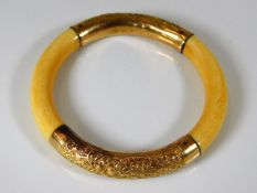 An antique ivory & 18ct gold bangle, acquired in B
