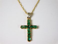 A small 9ct gold chain & crucifix set with green s