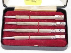A boxed set of four silver bridge pens