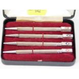 A boxed set of four silver bridge pens