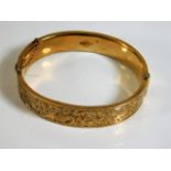 A 9ct gold engraved bangle