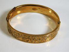 A 9ct gold engraved bangle