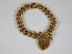 A 9ct gold curb link bracelet with padlock
