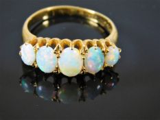 An early 20thC. 18ct gold ring with five opals