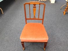 A low level upholstered Edwardian bedroom chair