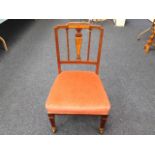 A low level upholstered Edwardian bedroom chair