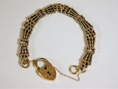 A four bar gate bracelet with padlock