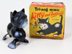 A wind up boxed kitty chasing butterfly