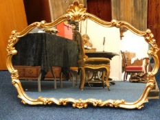 A large decorative gilt framed mirror