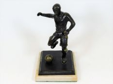 A mid 20thC. marble mounted bronze footballer