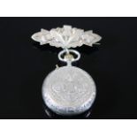 A silver ladies pocket watch with silver thistle f