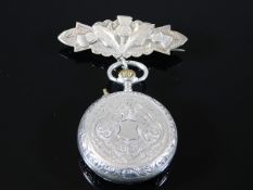 A silver ladies pocket watch with silver thistle f