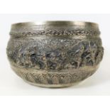 A large white metal Indian bowl with embossed figu