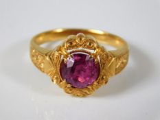 A yellow metal ring with approx. 1.5ct Burmese rub