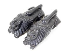 A pair of early 20thC. carved lion bookends