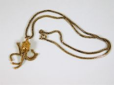 A 9ct gold necklace with similar decorative pendan