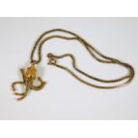 A 9ct gold necklace with similar decorative pendan