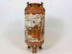 A Japanese satsuma vase supported by figurative fe