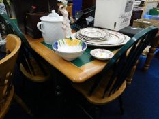 An extending tiled kitchen table with four chairs
