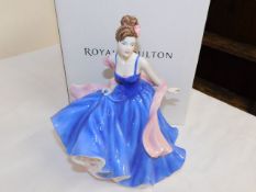 A boxed Doulton figurine First Love